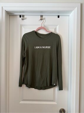FIGS Olive Green Long Sleeve Tee with "I AM A NURSE" Graphic